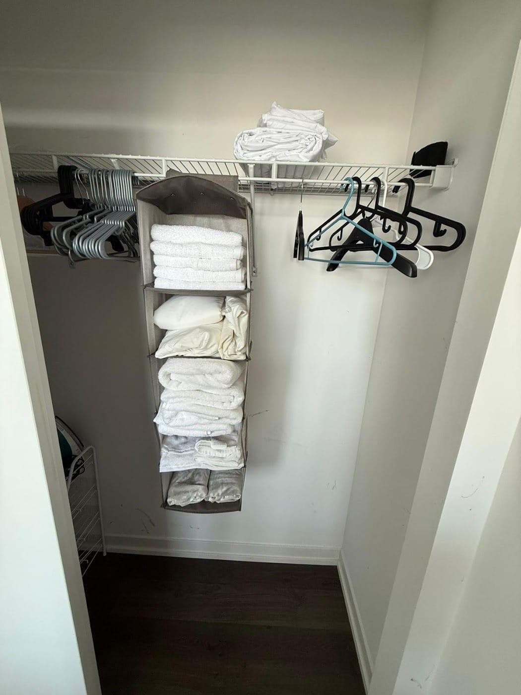 Folded white towels and linens on a shelf